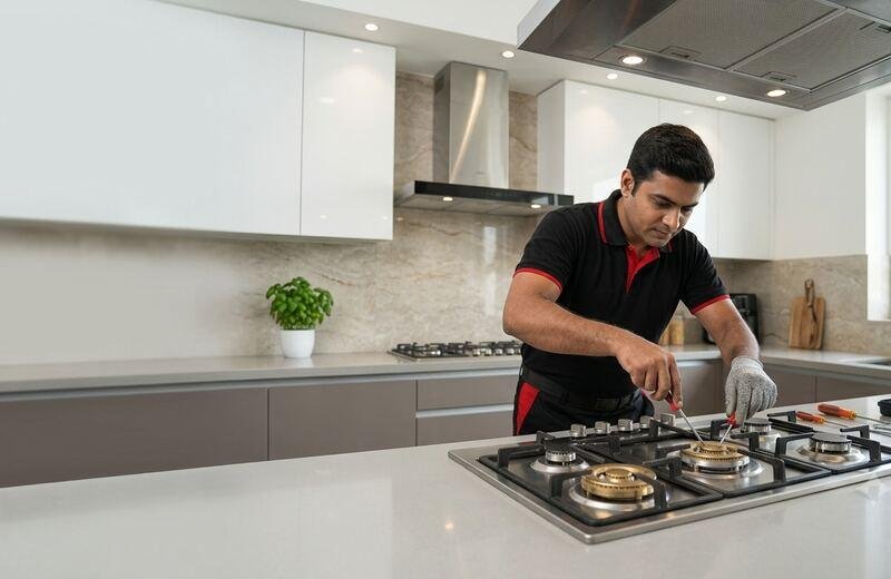 Technician repairing gas stove burner in modern kitchen - Stove Flame Care